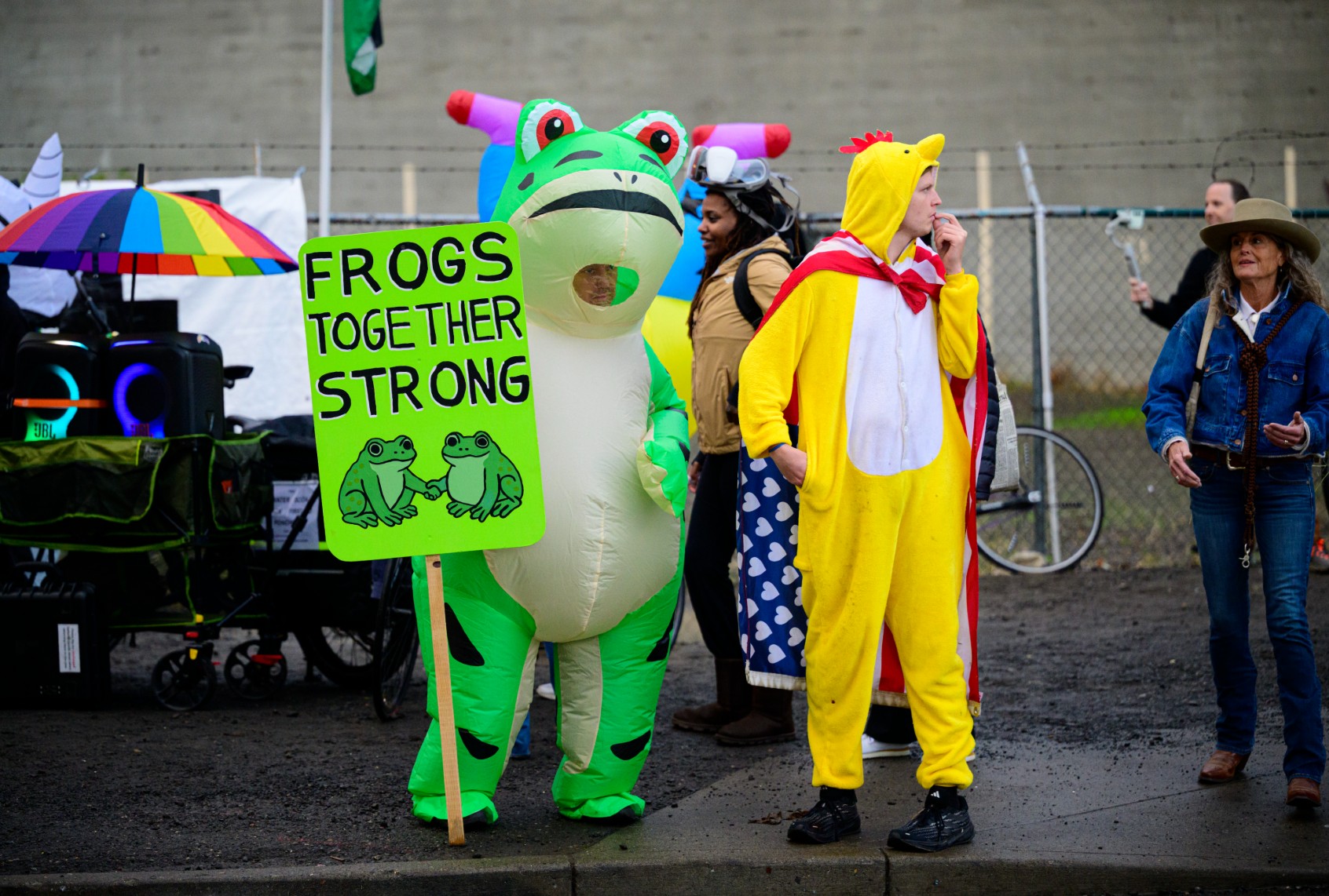 Frog protester with Frogs Together Strong sign at demonstration